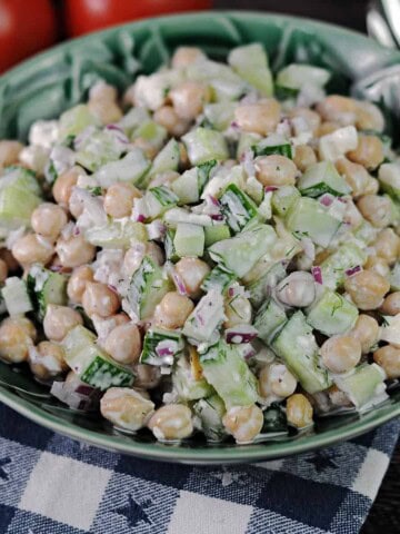 cucumber chickpea salad in a green serving bowl.