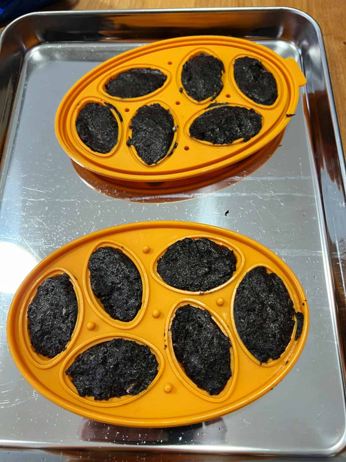 football molds filled with Oreo mixture.