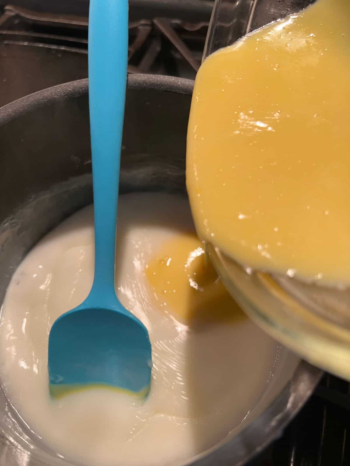 tempered egg mixture adding back to the saucepan.