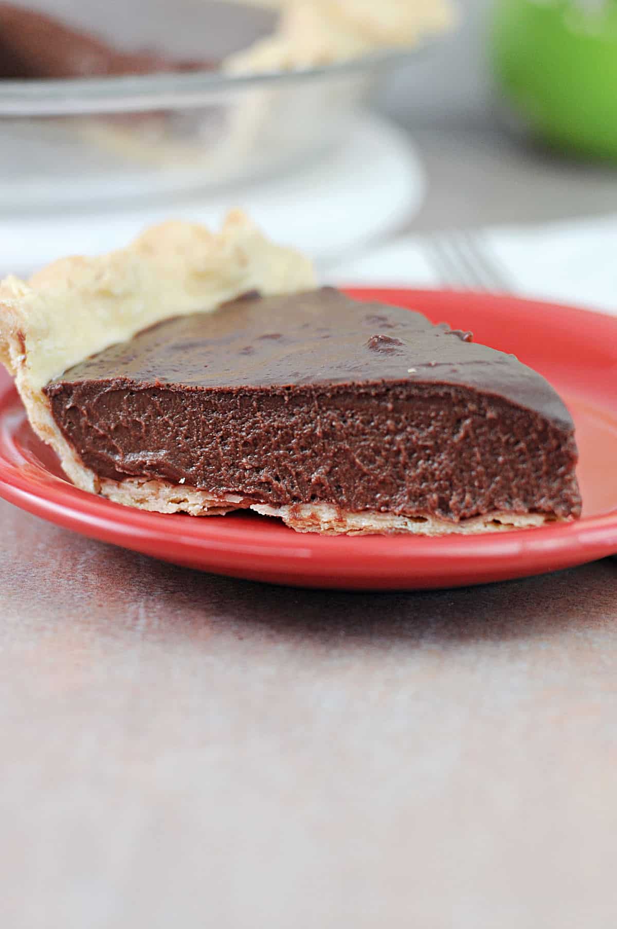 slice of no bake chocolate pie on a small red plate.