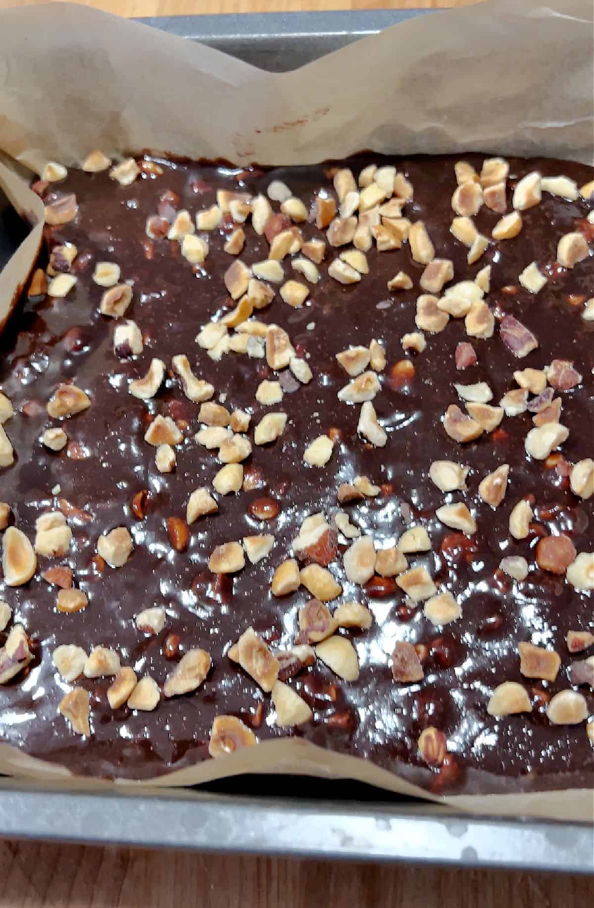 pan of keto nutella snacks with hazelnuts mixed in and on top.