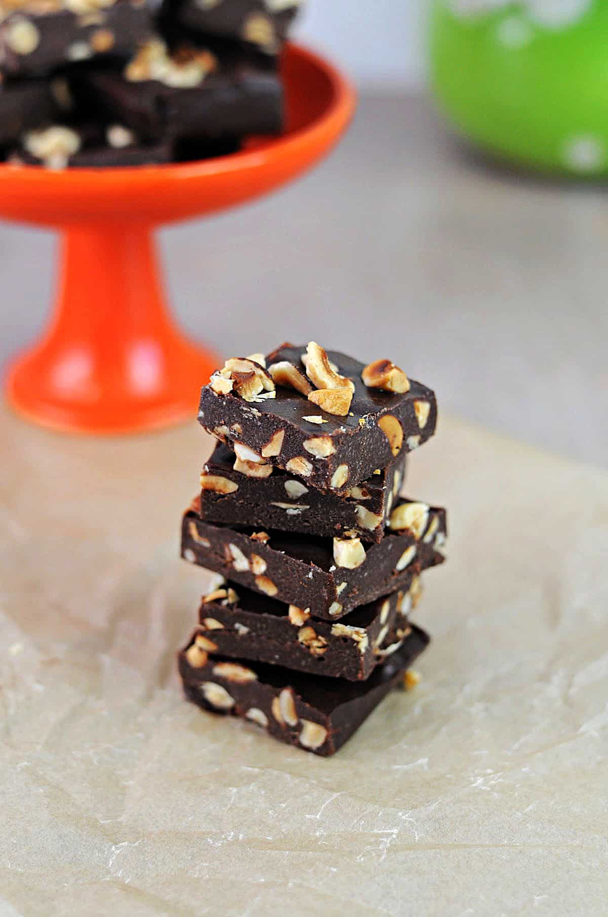 stack of keto nutella fat bombs filled with hazelnuts and cut into squares.