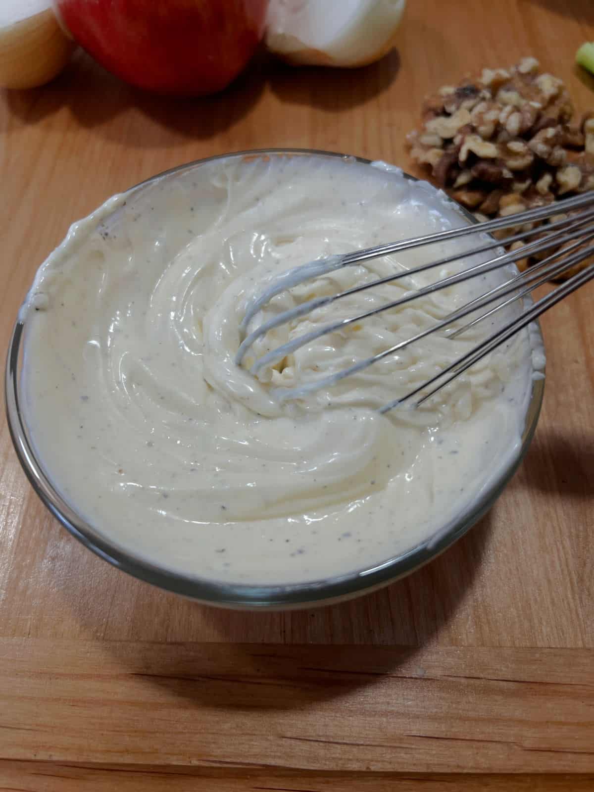small bowl of mayo, salt, and pepper being mixed with a whisk.