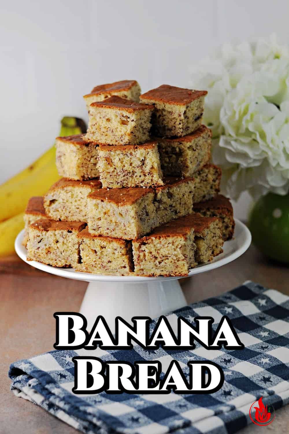Pin for banana bread showing stack of squares on a small cake server.
