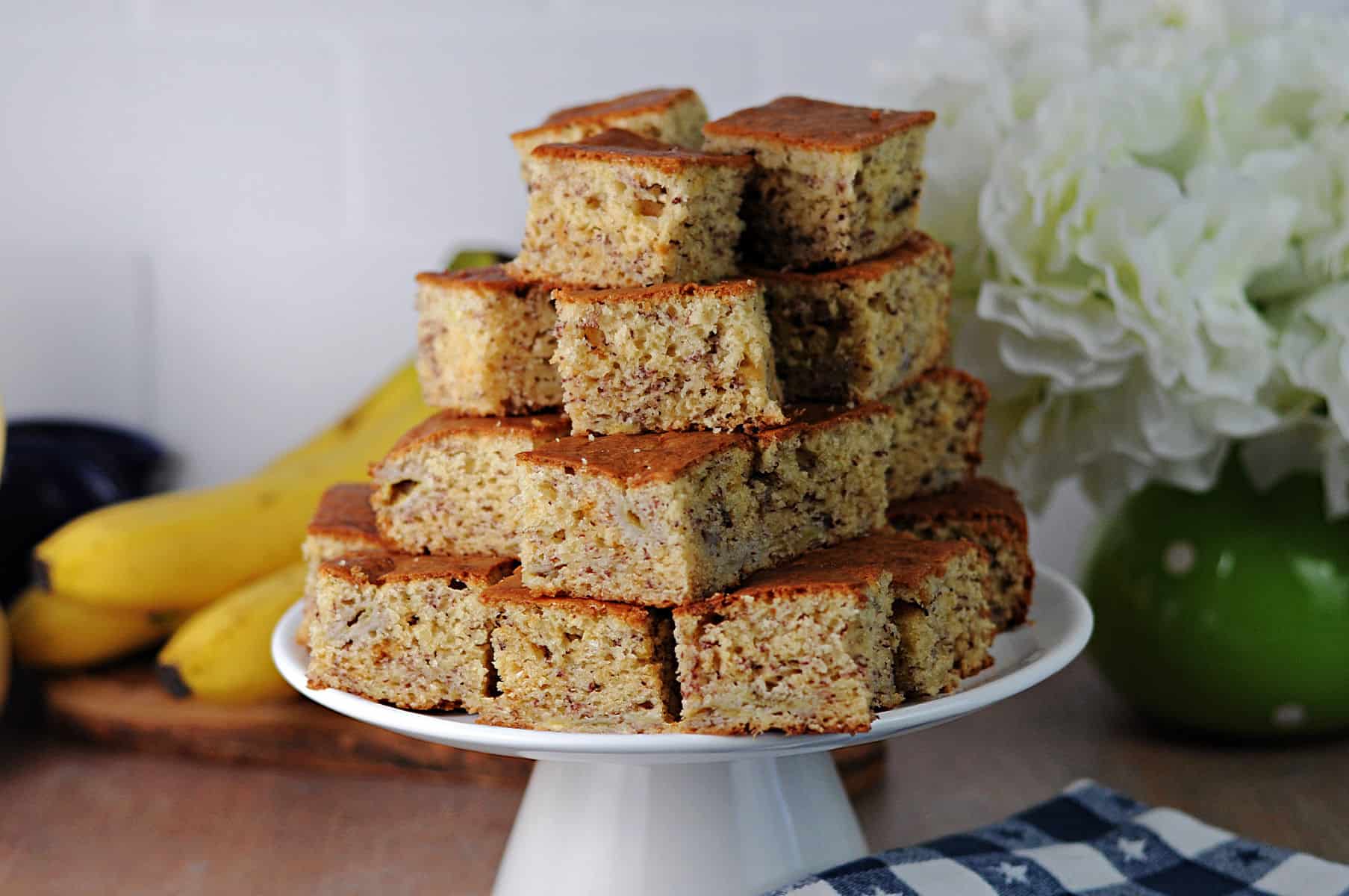 server piled high with squares of banana bread.