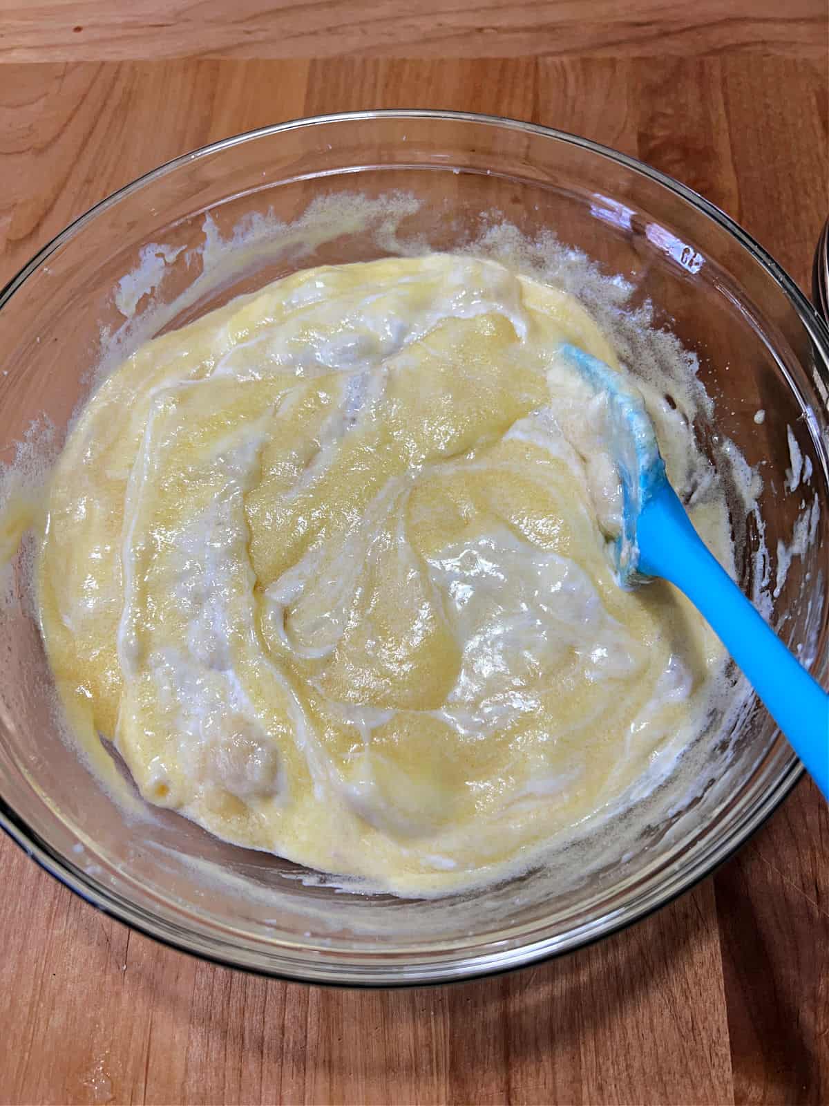 sour cream and banana mixture being added to the bowl.