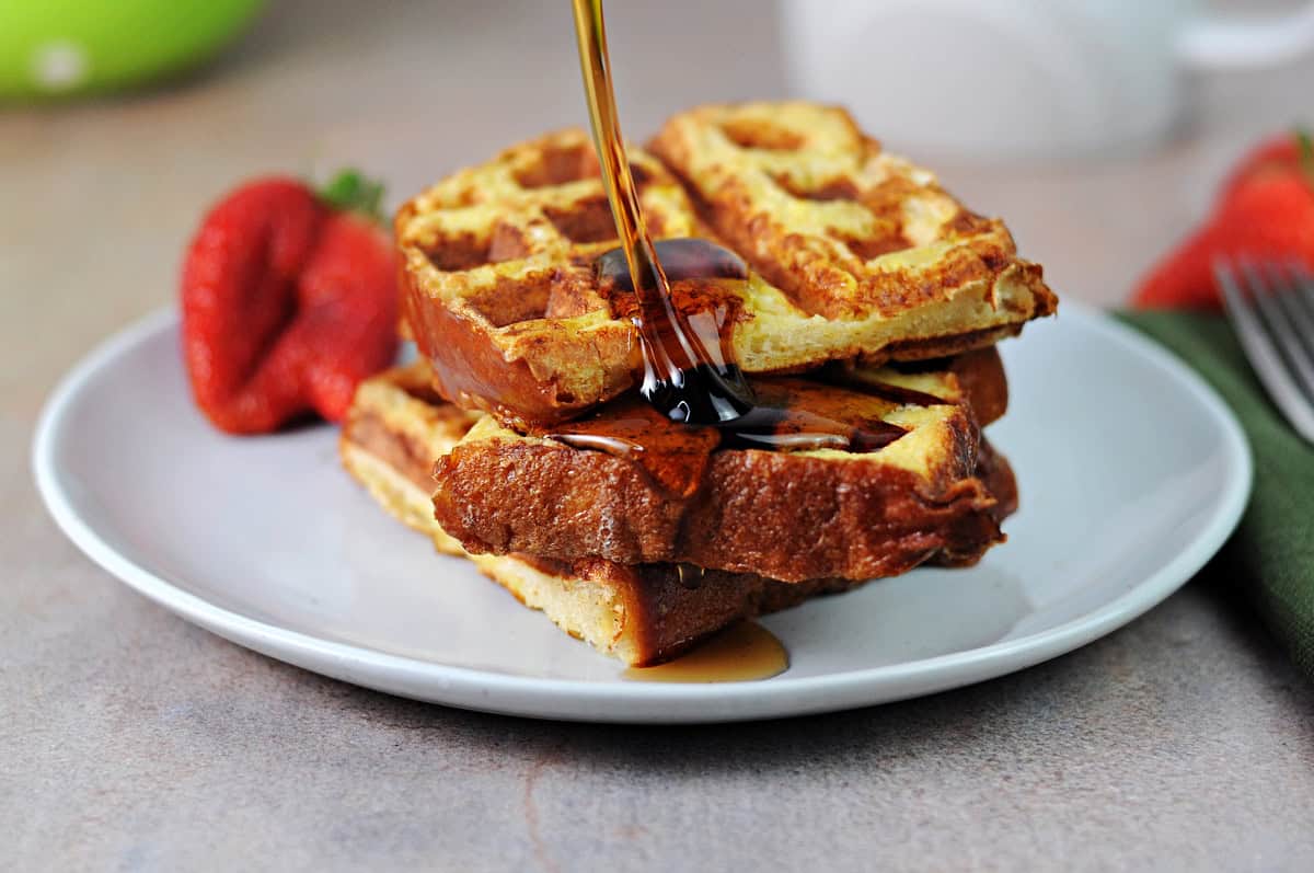 Drizzling syrup onto the french toast made in the waffle iron.