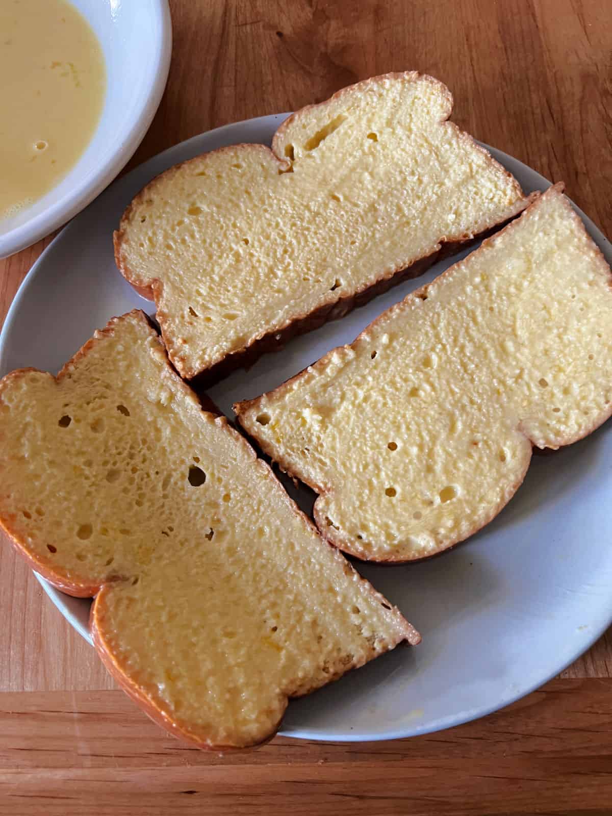 dipped bread slices on a plate.