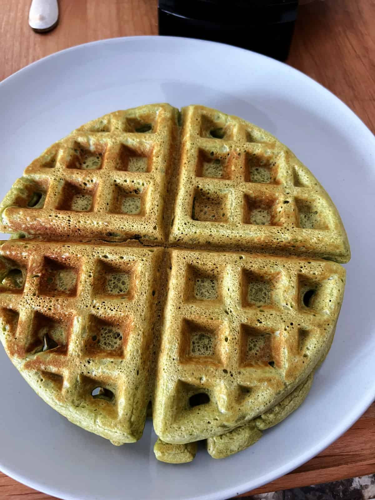 standard sized matcha waffle on a plate.