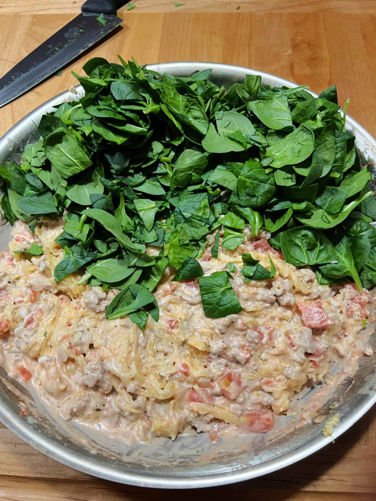 fresh spinach added to the skillet.