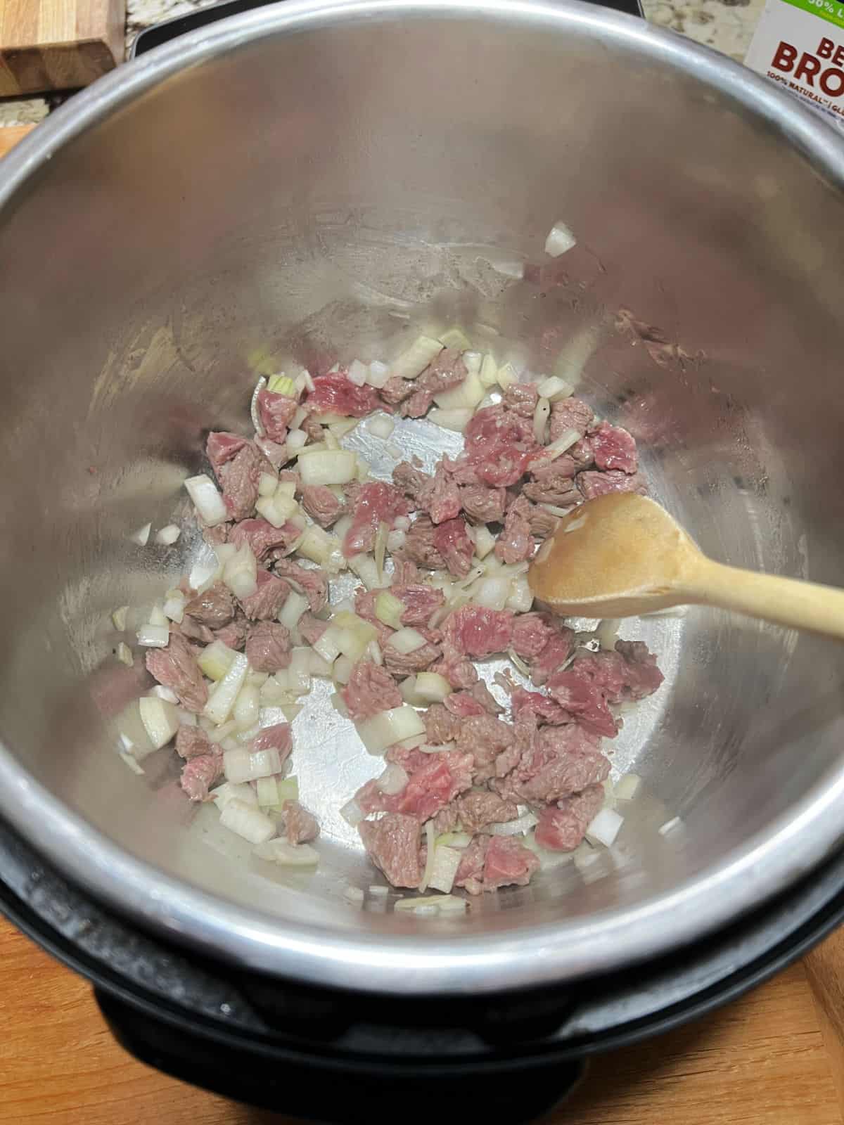 beef and onion getting sauteed.