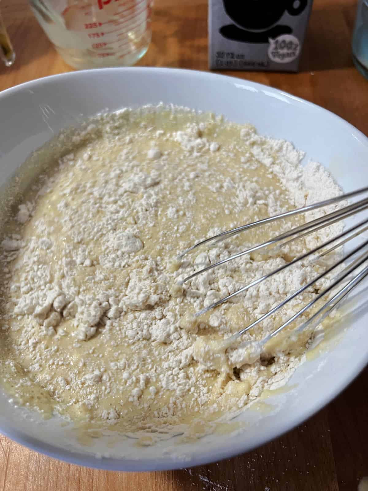 adding flour to make the batter.
