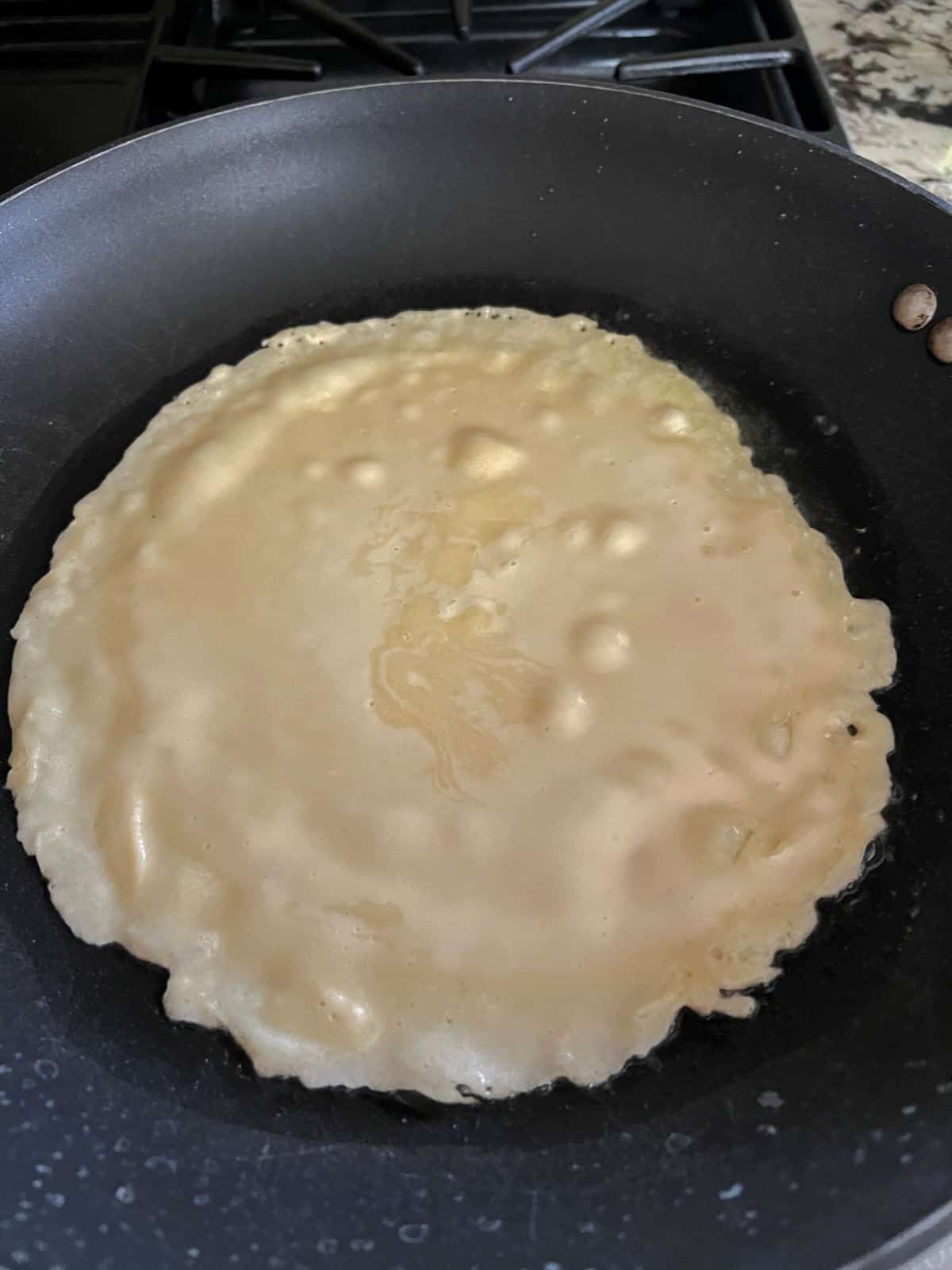 batter in the skillet beginning to cook.