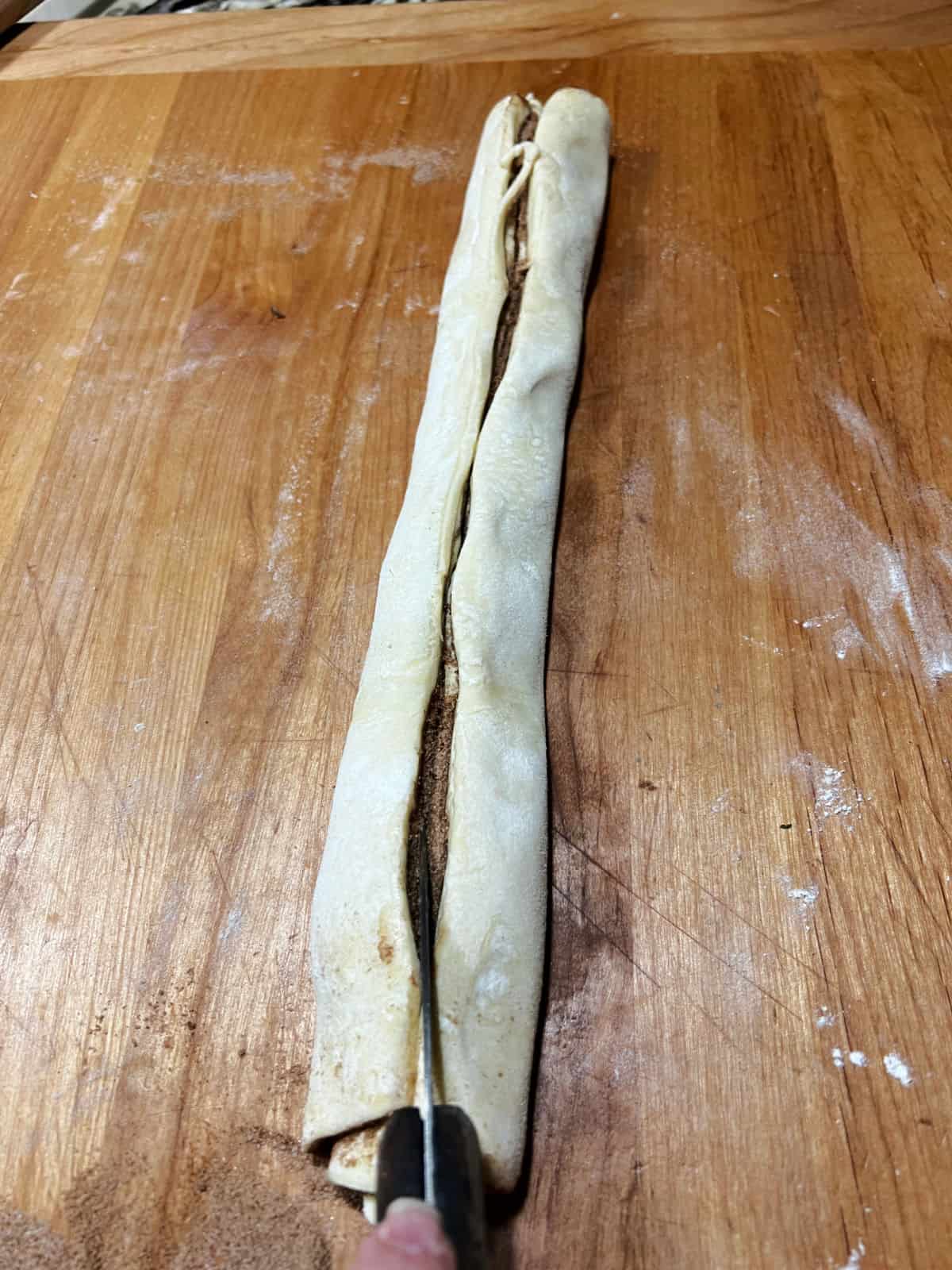 Cutting into the log shaped cruffin dough.