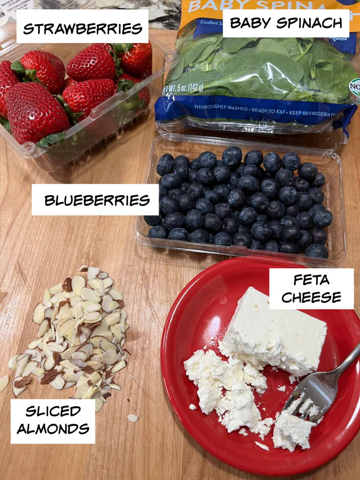 Ingredients: strawberries, blueberries, baby spinach, feta cheese, and sliced almonds.