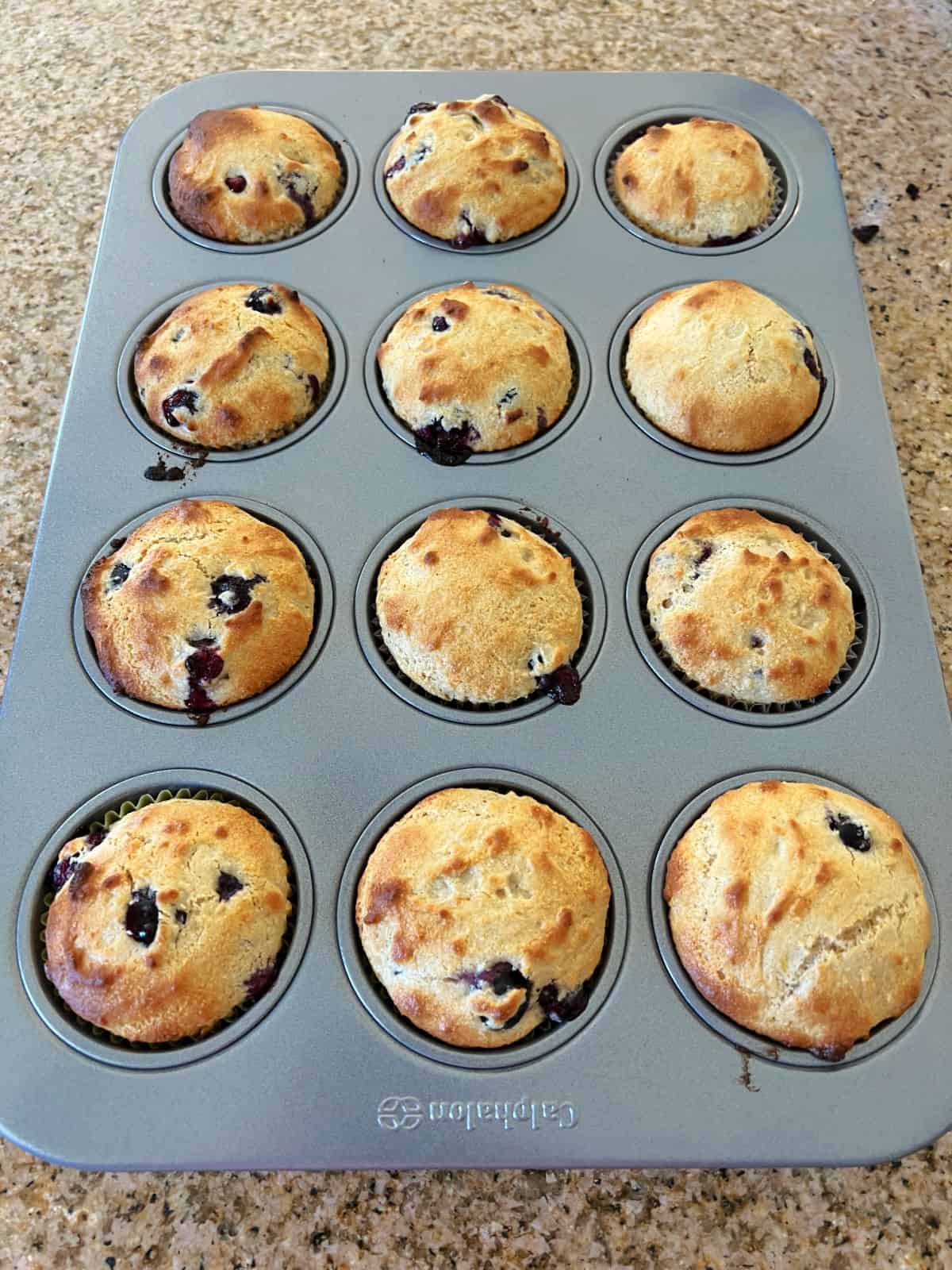 muffin tin filled with baked muffins.