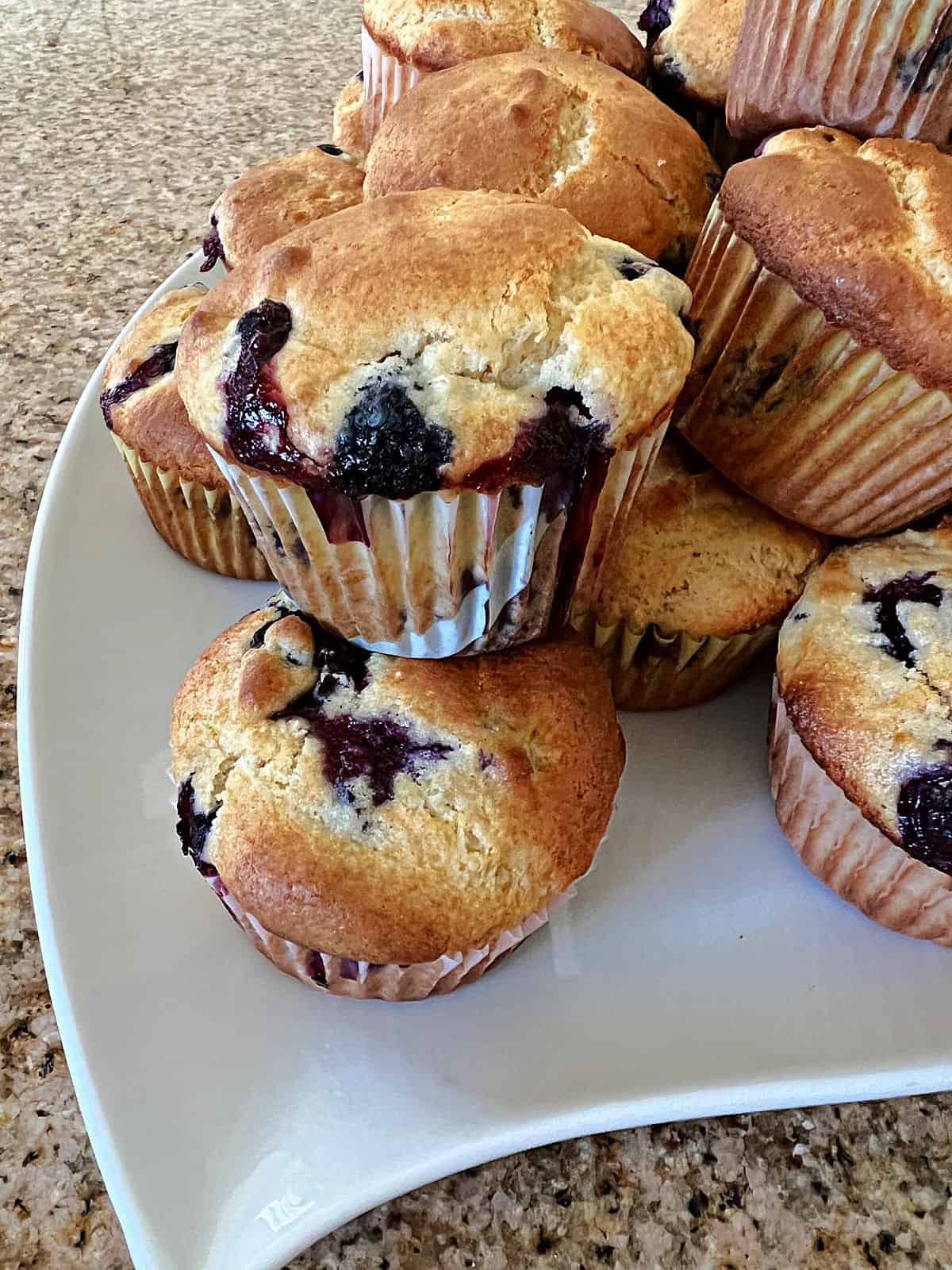 a tray piled with blueberry muffins made with pancake mix.