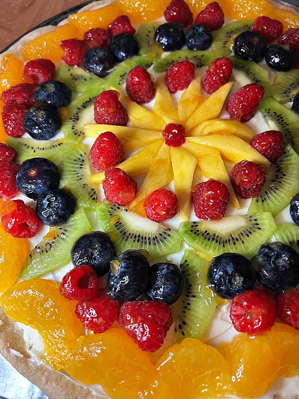 Close up of fully decorated fruit pizza.