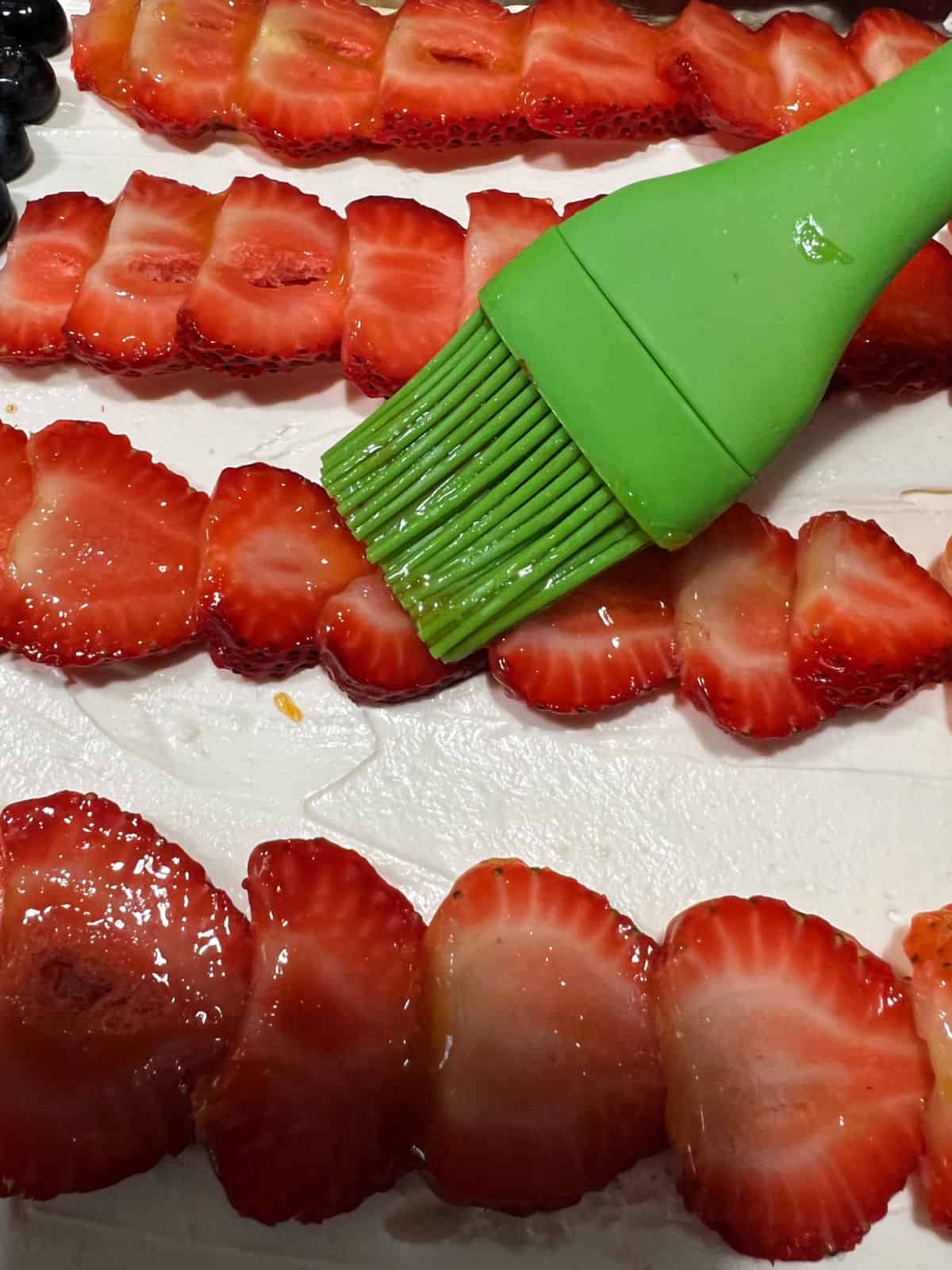 Pastry brush adding a little apricot preserves to the fruit.