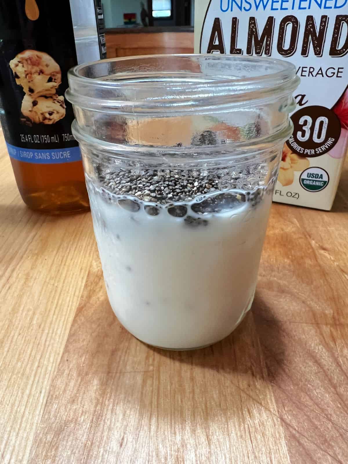 Almond milk and chia seeds in a small jar.