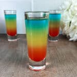 Rainbow shots ready to serve, with distinct blue, yellow, and red layers.