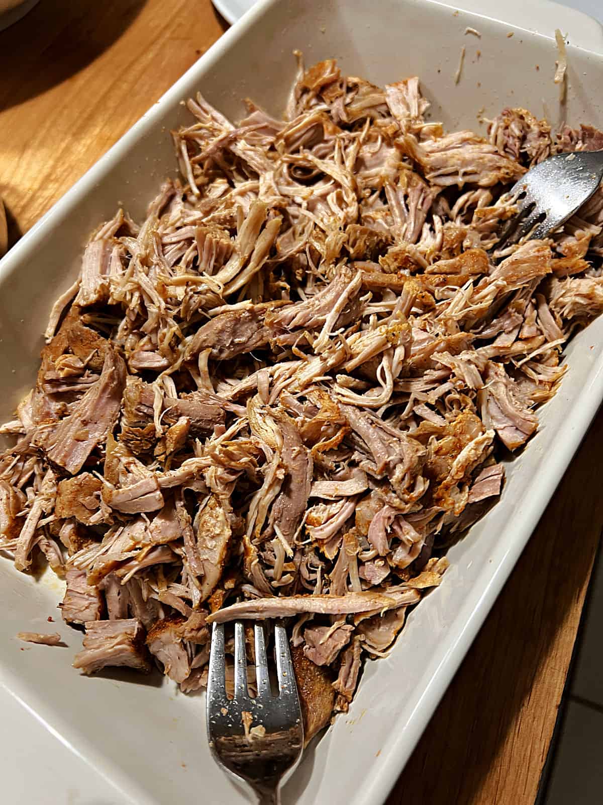 2 forks shredding the pulled pork, removed from the Instant Pot.