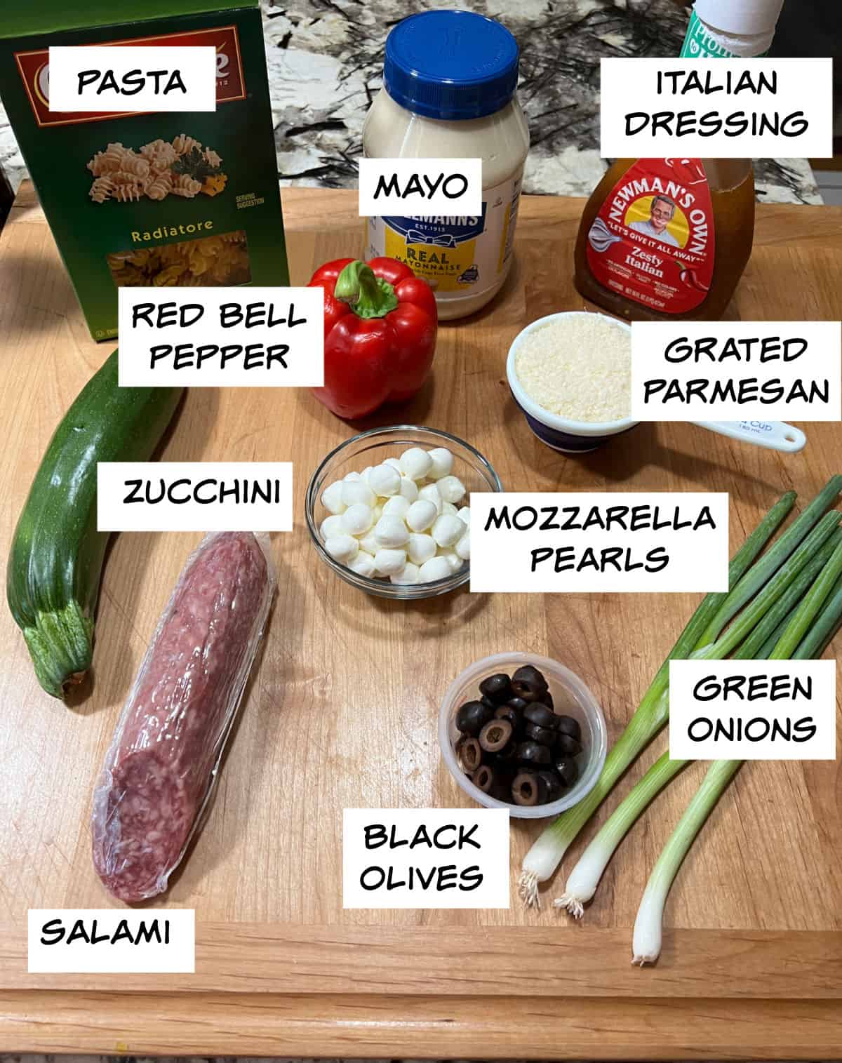 Ingredients needed: pasta, salami, Italian dressing, mayo, Parmesan cheese, red bell pepper, mozzarella pearls, green onions, and black olives.