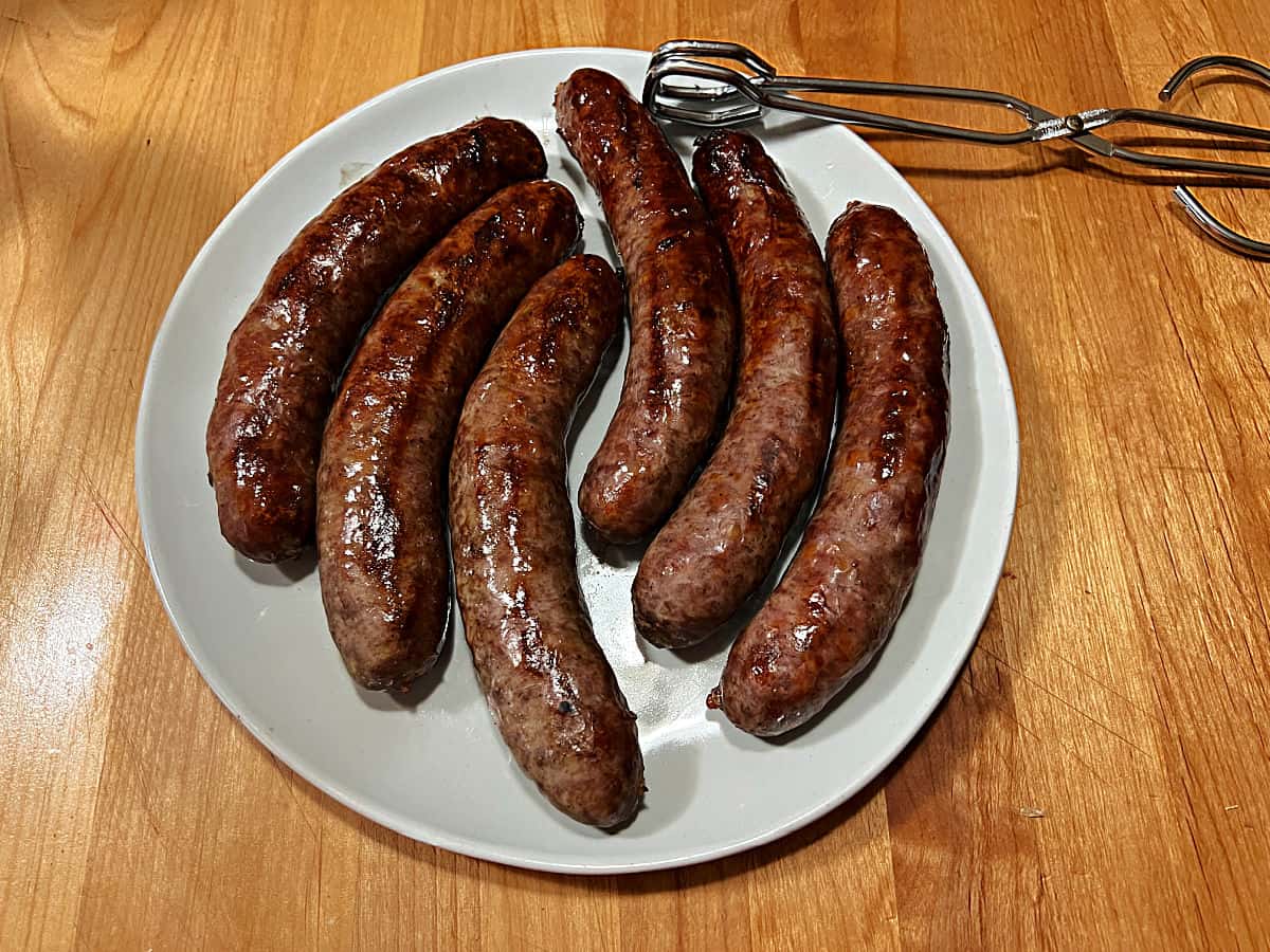 Plate of grilled bratwurst ready to eat.