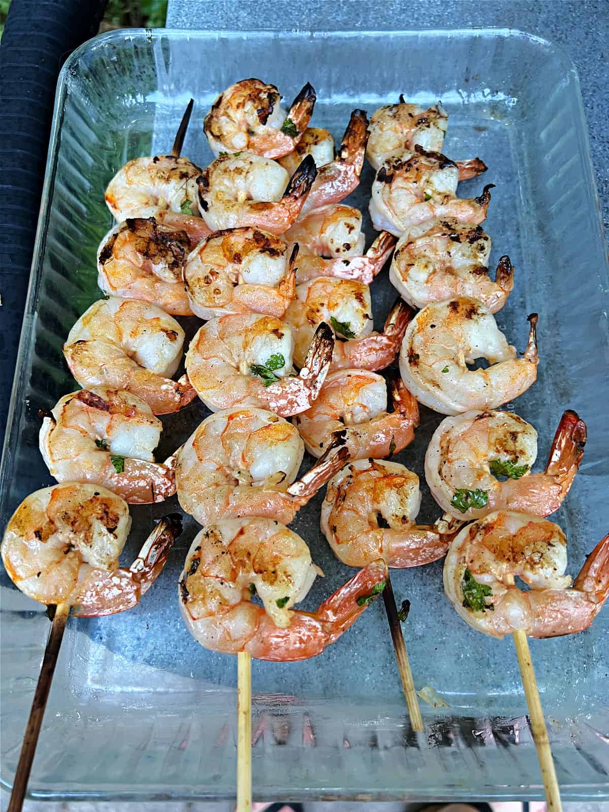 Cooked shrimp skewers removed from the grill.