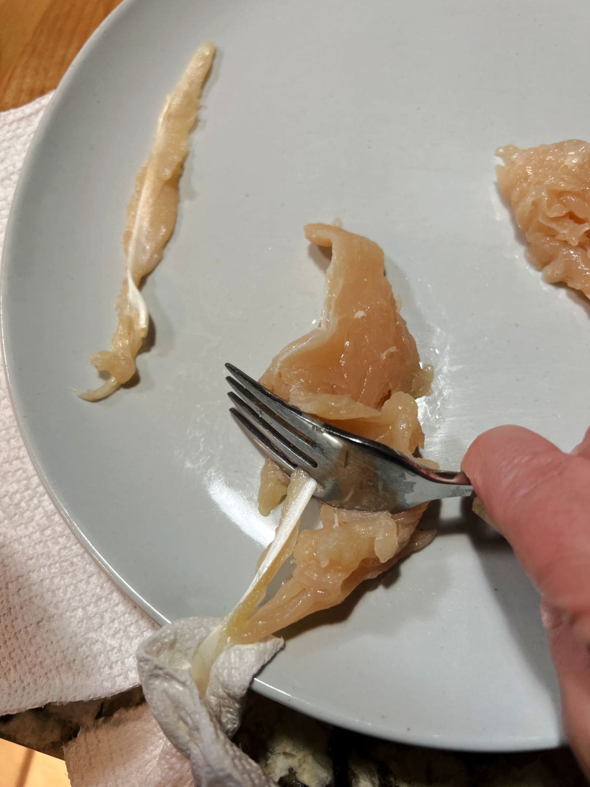 Using a fork to remove the tendon.