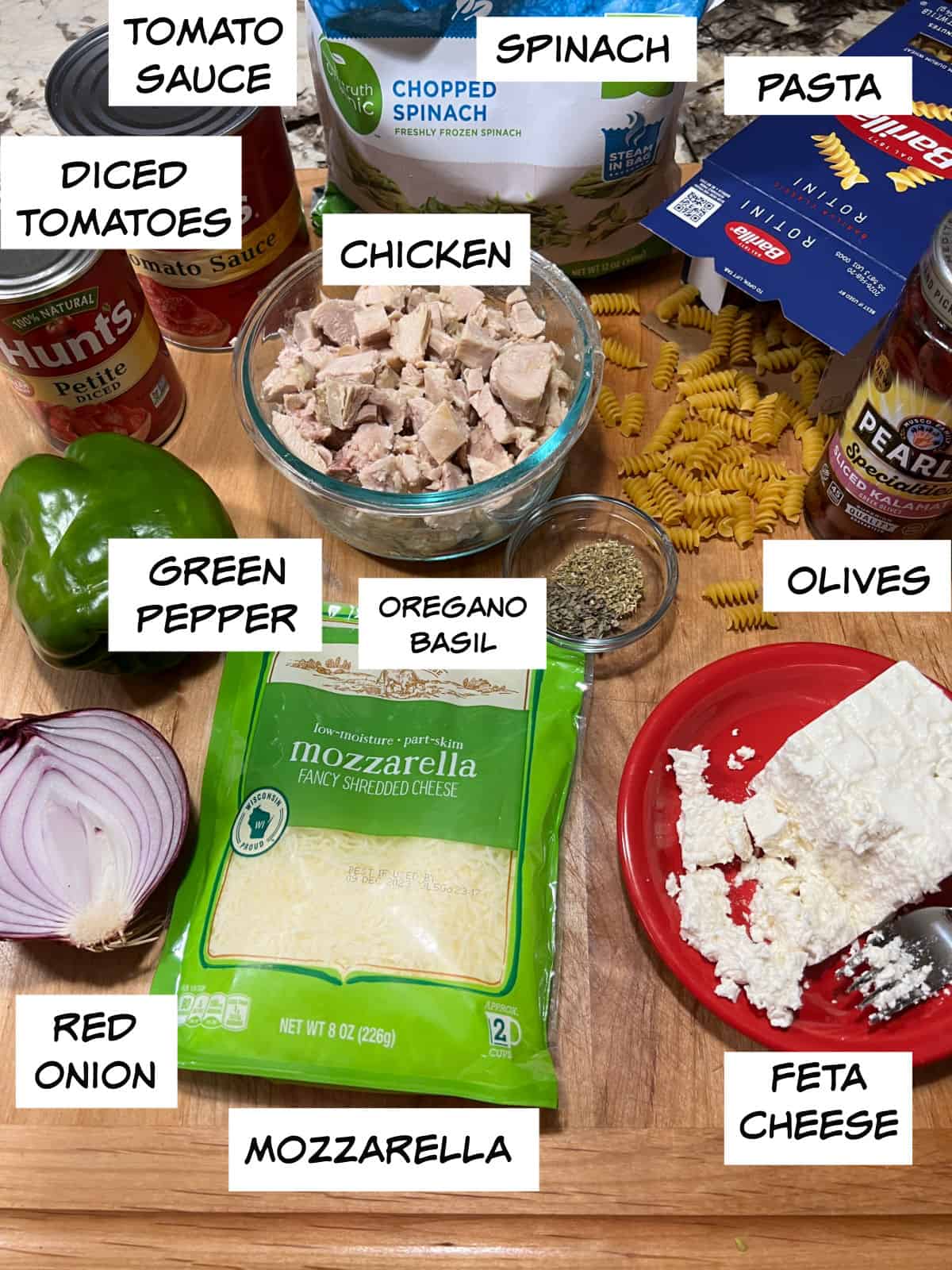 Ingredients: chicken, tomato sauce, diced tomatoes, spinach, pasta, green pepper, olives, feta cheese, mozzarella, red onion, oregano and basil.