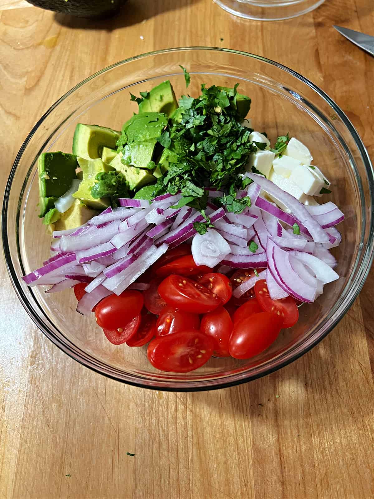 Undressed salad ingredients in the mixing bowl.