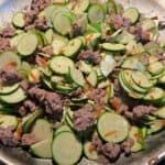 sausage zucchini casserole cooking on the stove top.