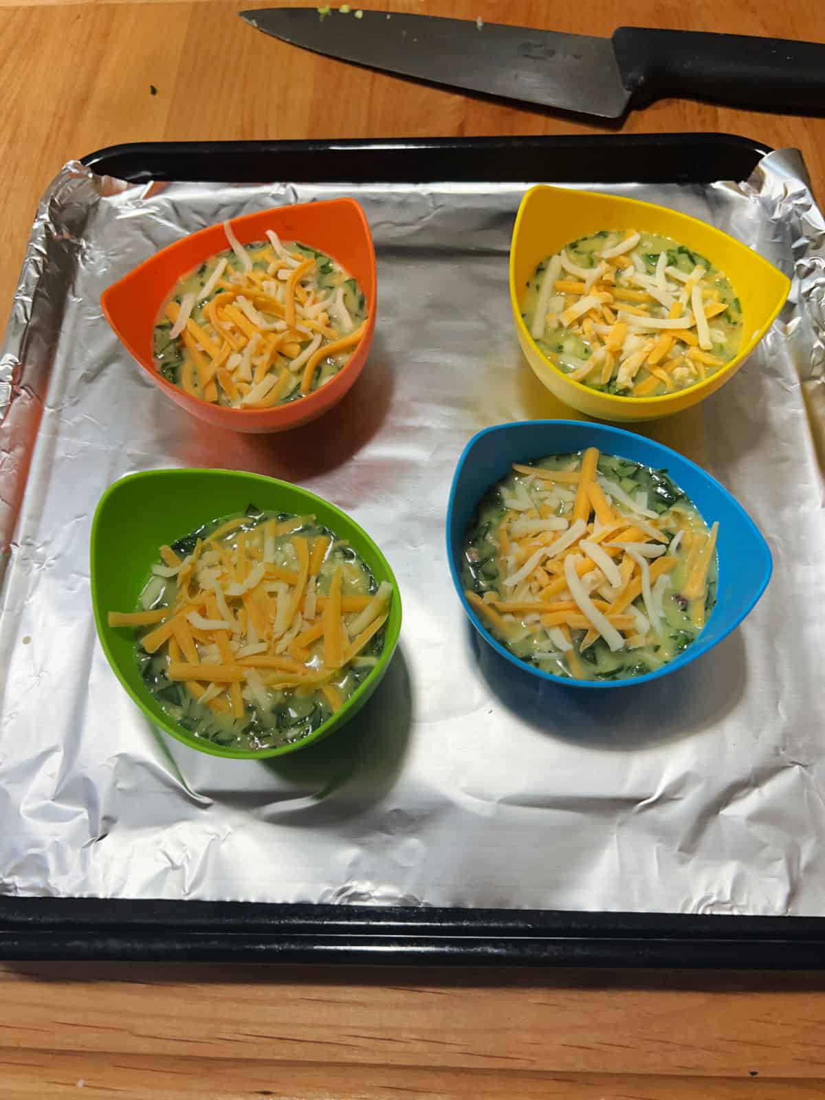 Cheese sprinkled on top of each uncooked cup.