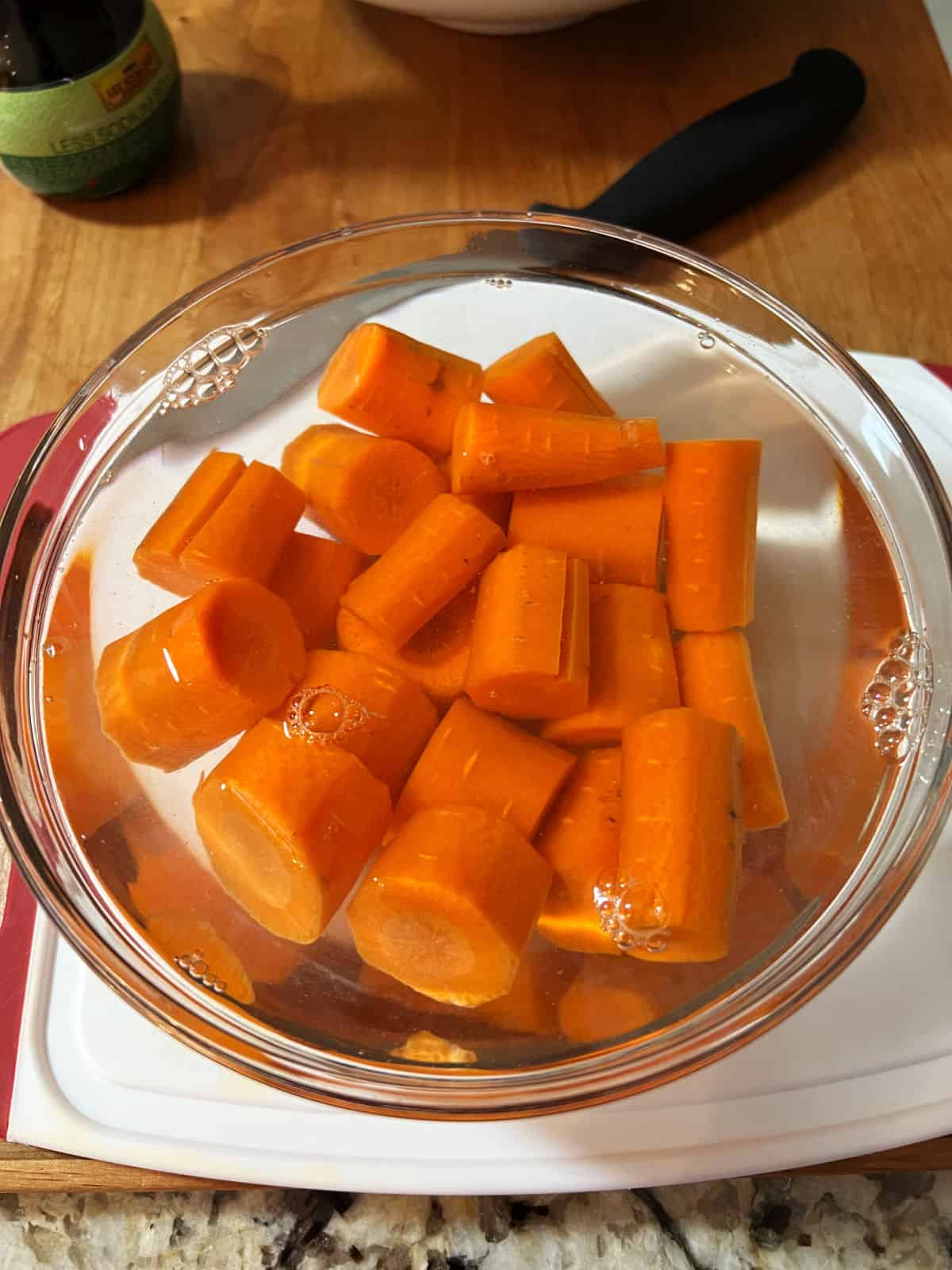 bowl of carrots immersed in water.