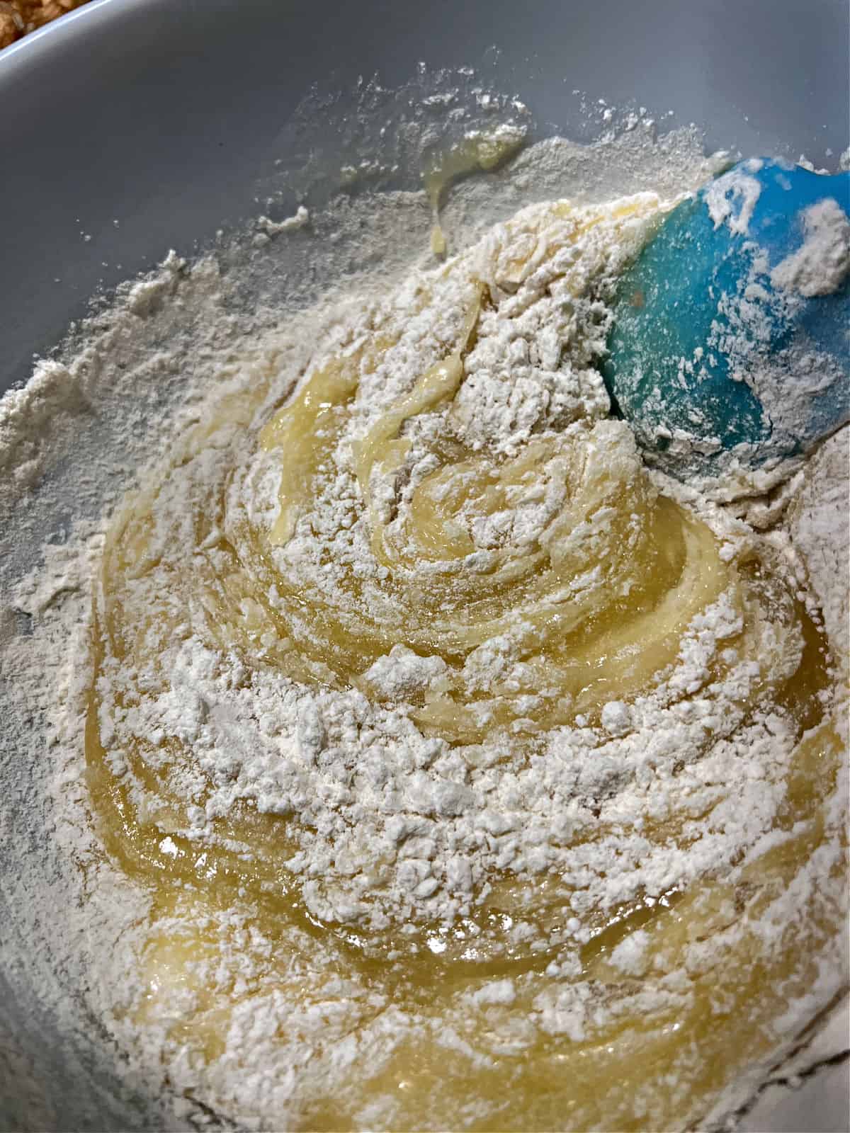 Mixing dry ingredients into the batter.