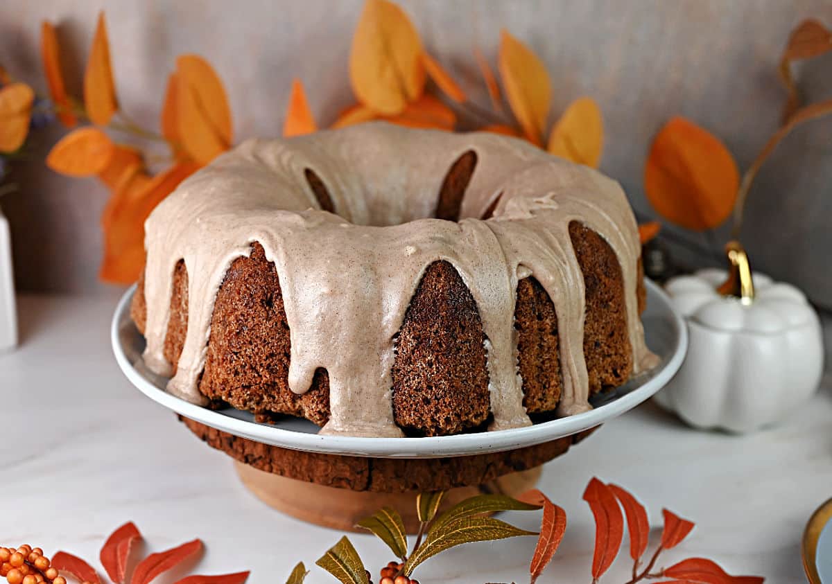 Old fashioned fresh apple cake made in a Bundt pan and drizzled with a thick cinnamon glaze frosting.