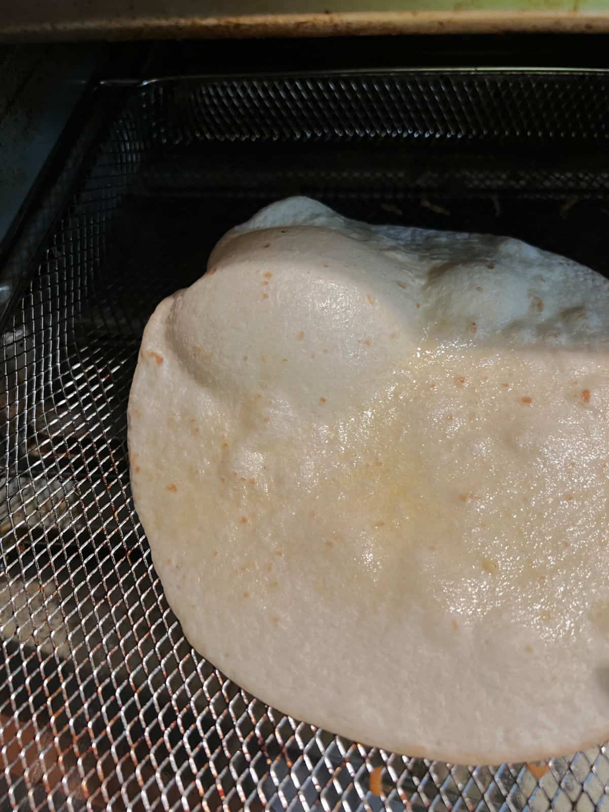 Large bubble in a cooking tortilla.