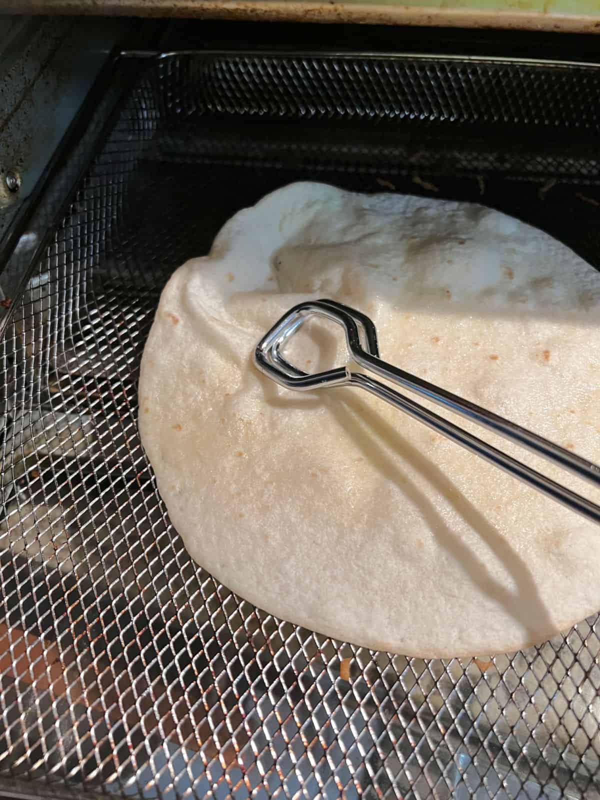 Using a tongs to press out the air bubble.