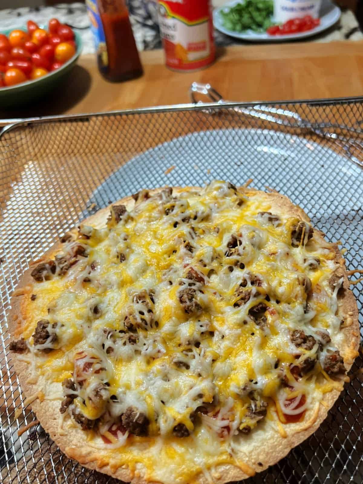 Air fried pizza showing melted cheese.