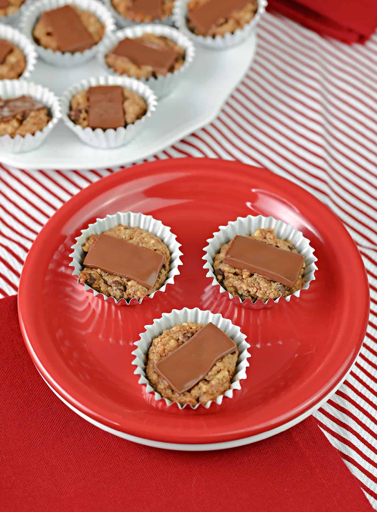 3 French Christmas cookies on a small red plate.