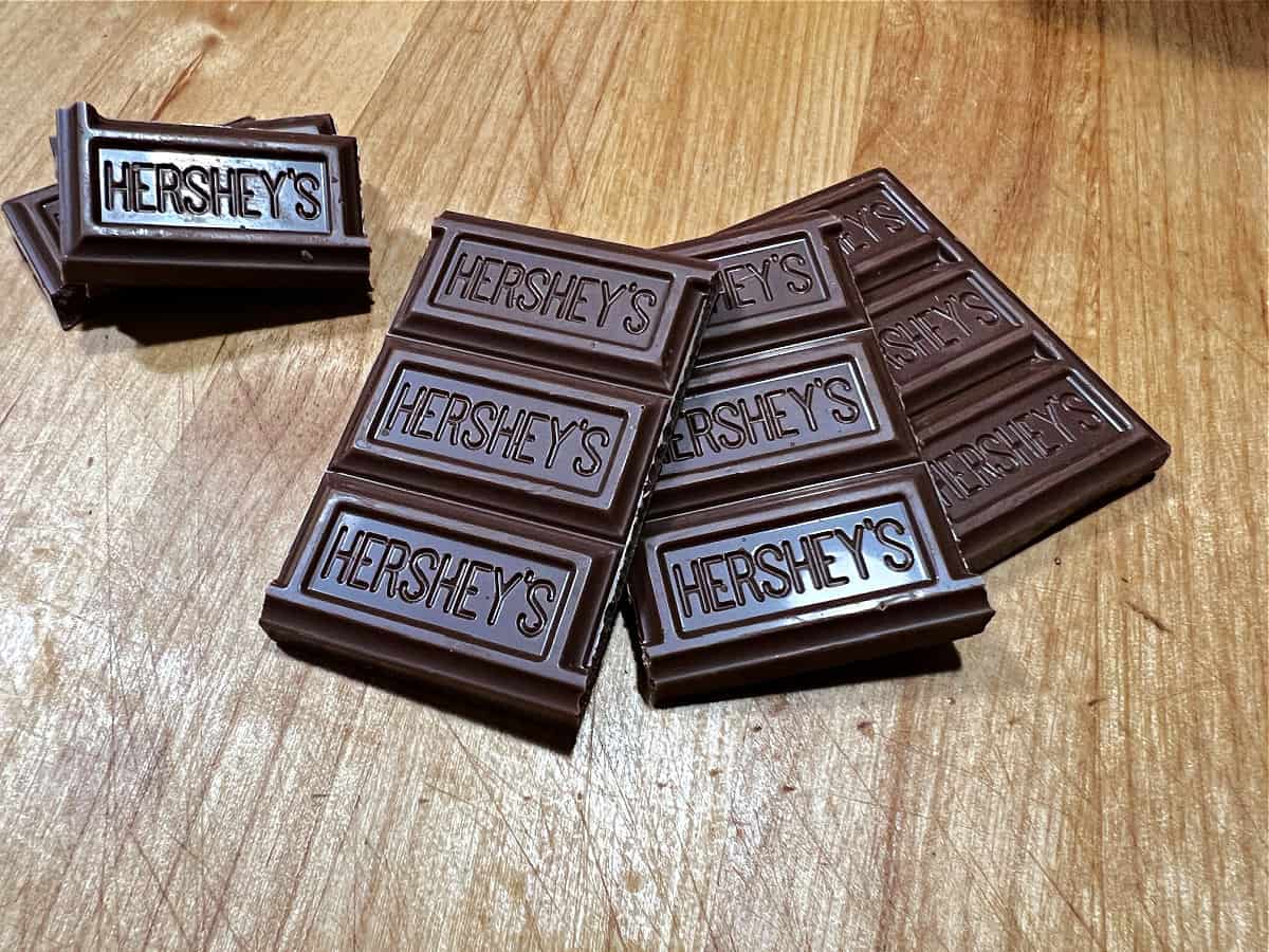 Breaking the Hershey bars into pieces.
