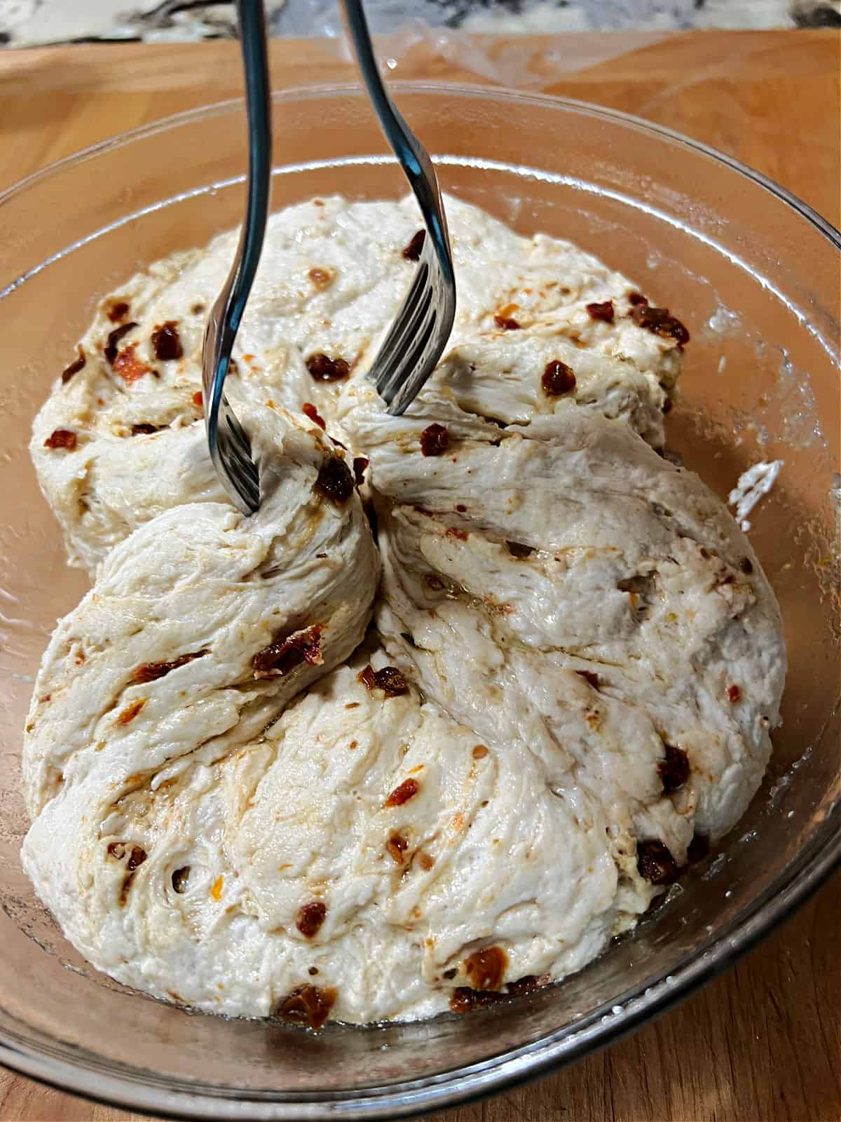Using 2 forks to re-shape the dough into a ball.