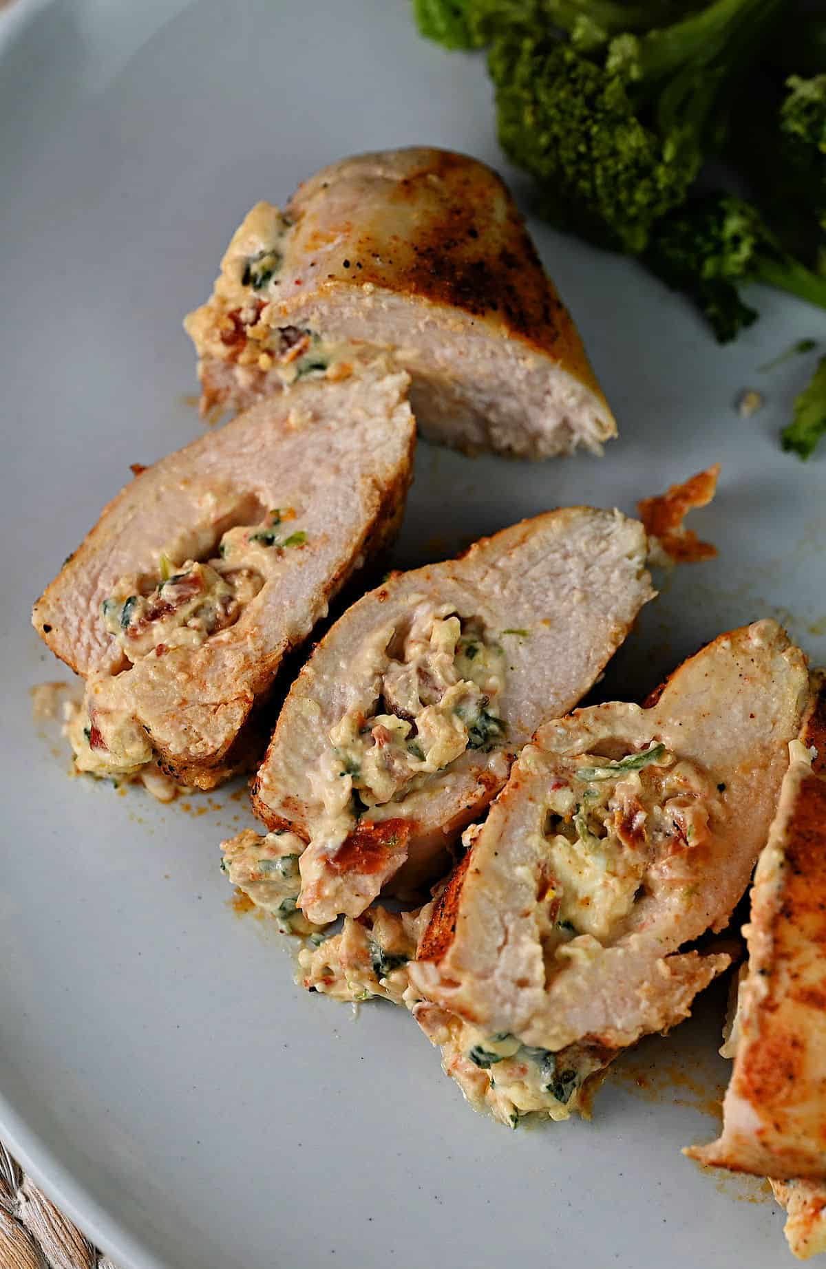 air fryer cooked stuffed chicken breast in slices on a plate.