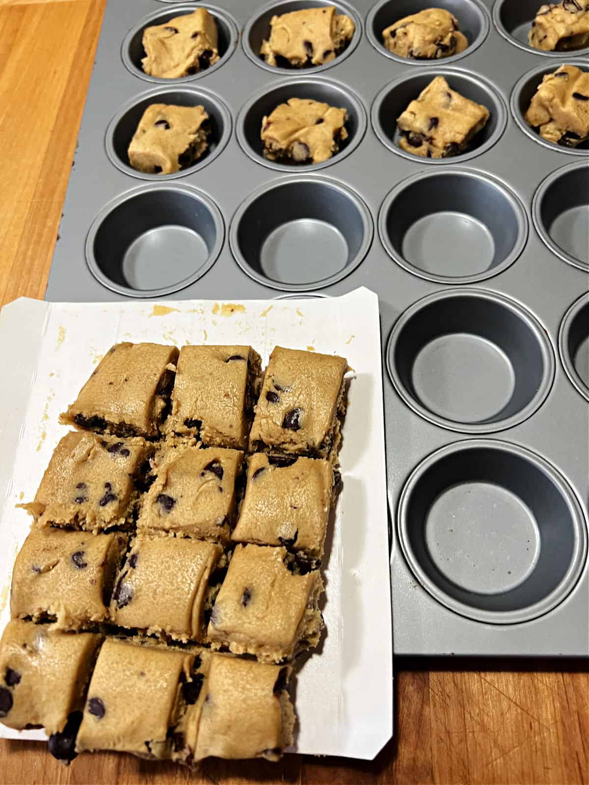 Placing the squares of dough into the mini muffin pan.