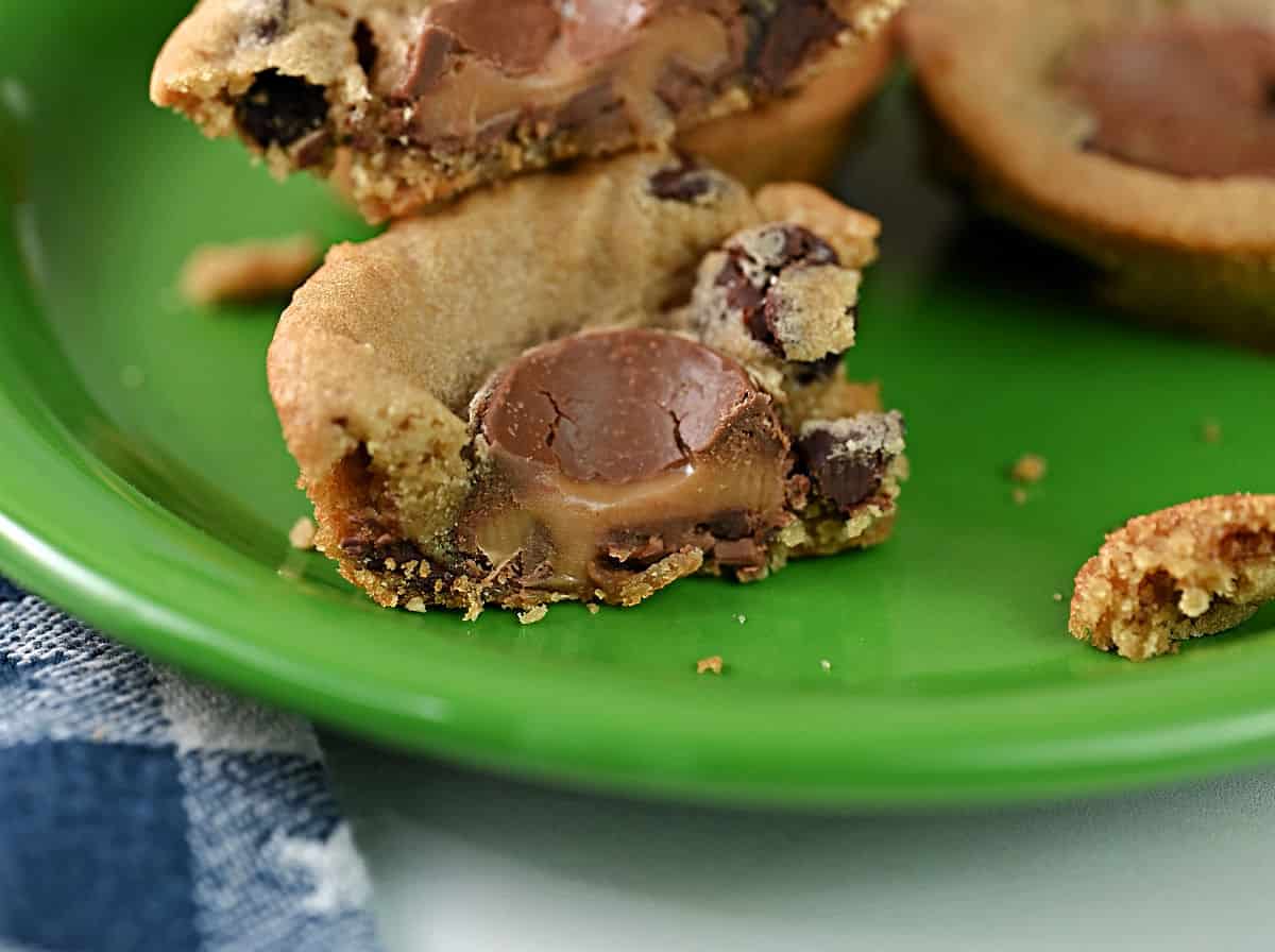 close up of a chocolate chip cookie cup showing it was stuffed with a rolo candy.