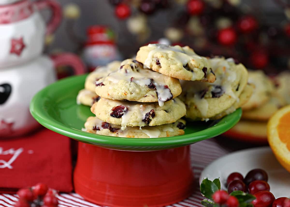 A stack of cranberry orange cookies on a green plate.