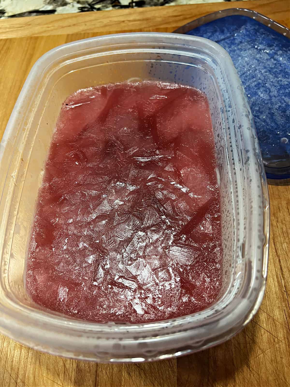 Frozen cranberry rum slush mixture ready to scoop.