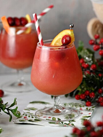 Cranberry orange vodka slush in a stemmed glass.
