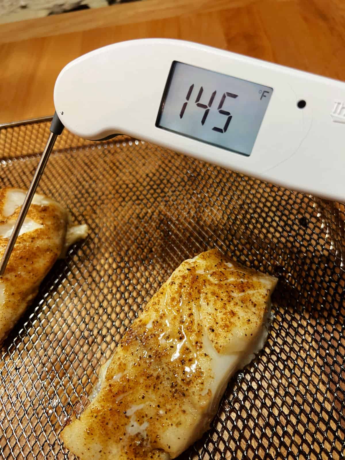 Meat thermometer showing internal temperature of 145F.